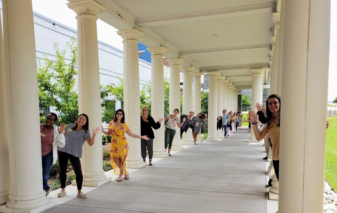 James Madison University Office of Disability Services Staff waving hello under colonnade