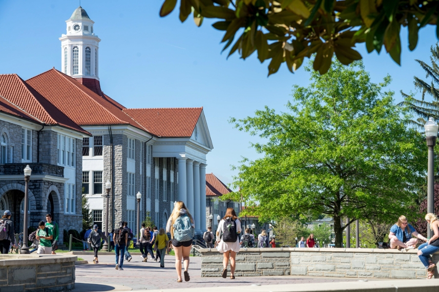 Wilson Hall from the side with students walking on the quad