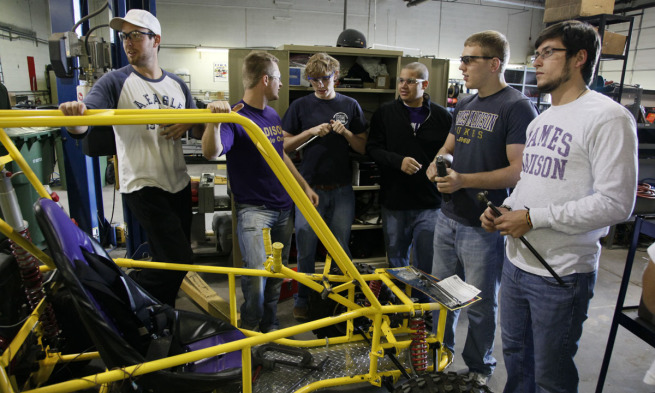 Students stand around alternative fuel vehicle