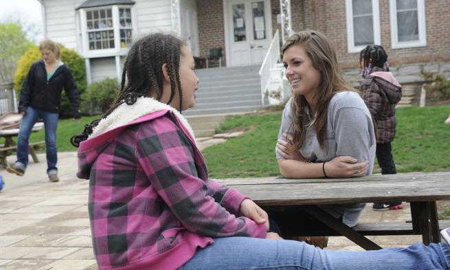 A JMU nursing student chats with a Harrisonburg child