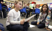 Two students read for their teacher