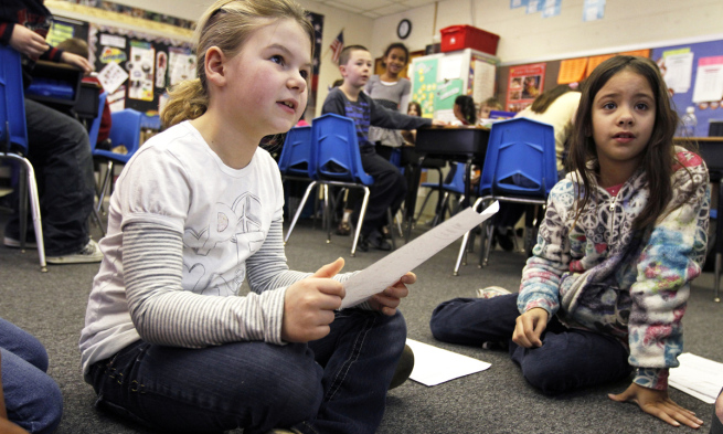 Two students read for their teacher