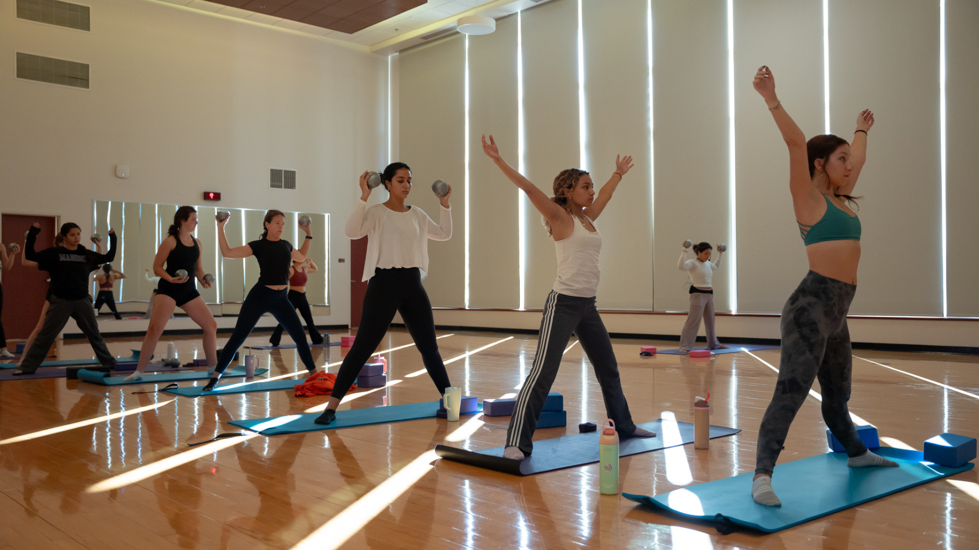students stretching as part of their workout class