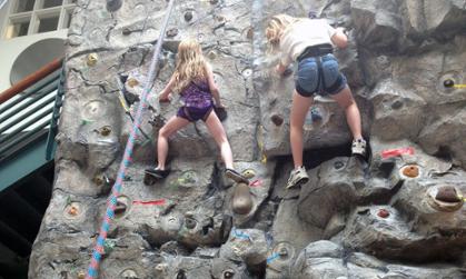 Two Campers Climb Rock Wall