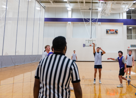 Officials watching a basketball game