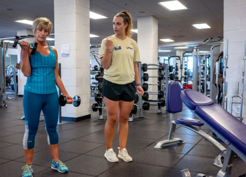 personal trainers showing how to do a bicep curl