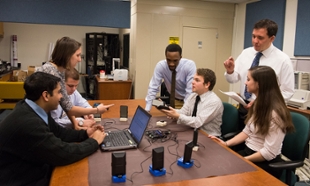 The team discusses progress of the hearing test system that patients will set up and use themselves.