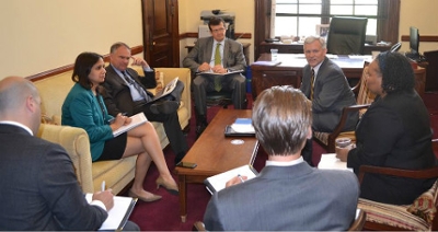 Vice Provost for Research & Scholarship Yvonne Harris briefs U.S. Senator Tim Kaine on regional economic development projects.