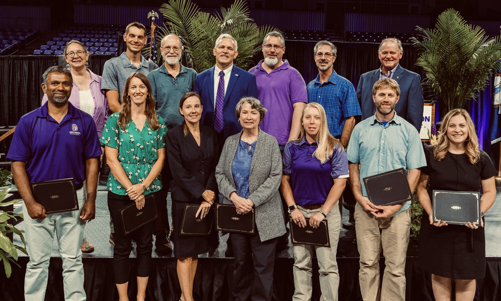 Team members photographed with awards