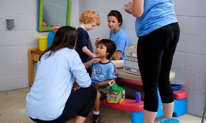 Photo of JMU students working with kids 