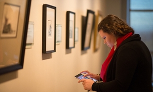 Visitor gets information on Rembrandt exhibit