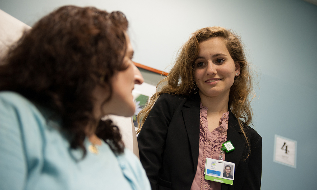 Anna Young talks to patient during her work at hospital