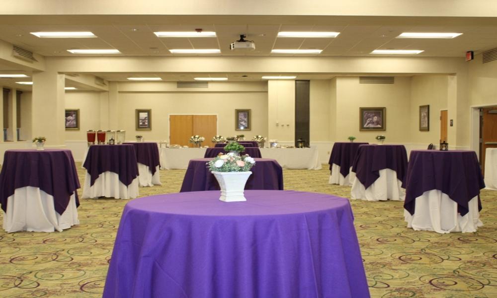 Tables with purple tablecloths