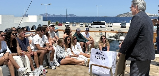 students sitting on deck of boat on study abroad trip