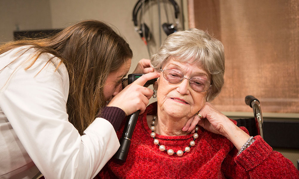 An audiology student conducts an exam