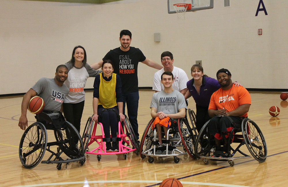 JMU students pose with wheelchair basketball athletes.