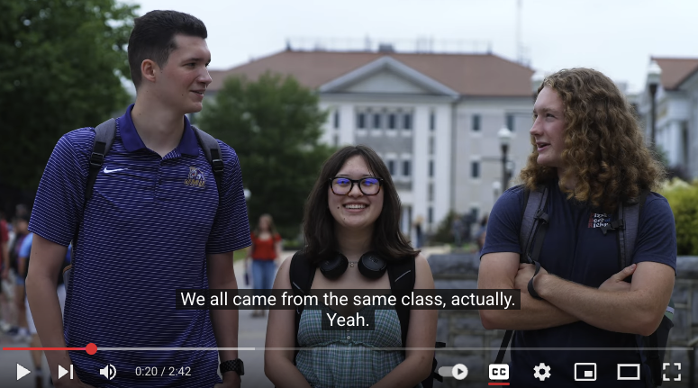 Screenshot of YouTube video with three students and closed captions displaying their conversation.