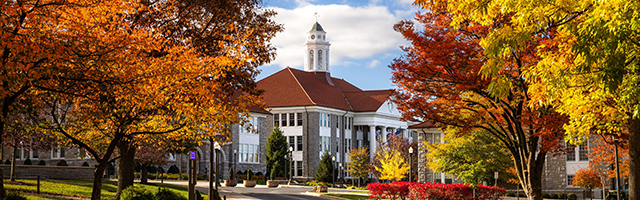 Photo of Wilson Hall between Colorful Fall Trees