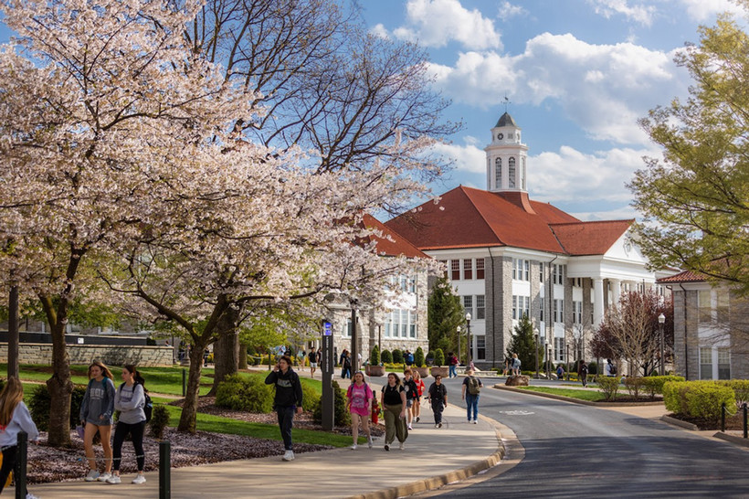 Picture of Wilson Hall with students walking on the sidewalk