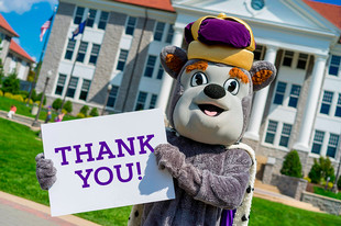 Duke Dog holding up a Thank You sign