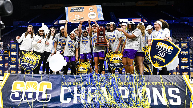 JMU womens basketball celebrating their win over Troy