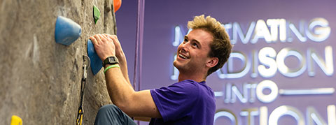 Photo of student at the climbing wall in UREC