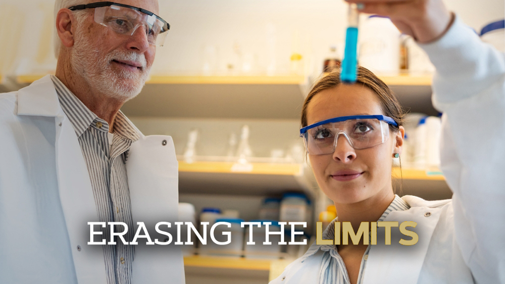 student working with her professor in a lab