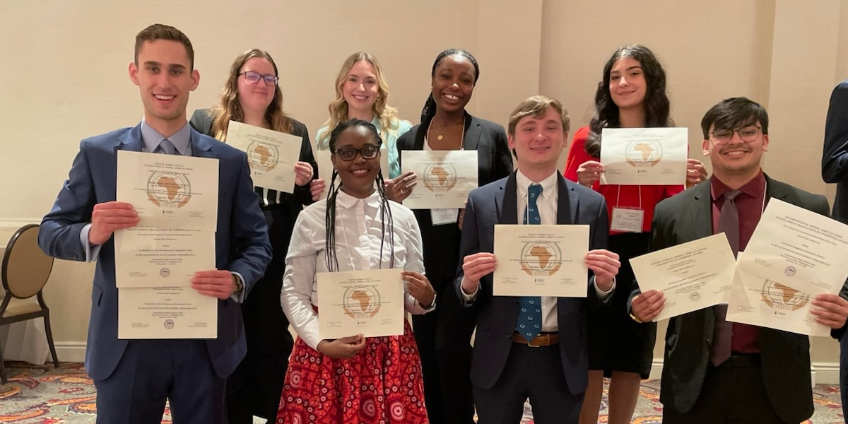 Photo of the IMAU team and Dr. Muzata with award certificates