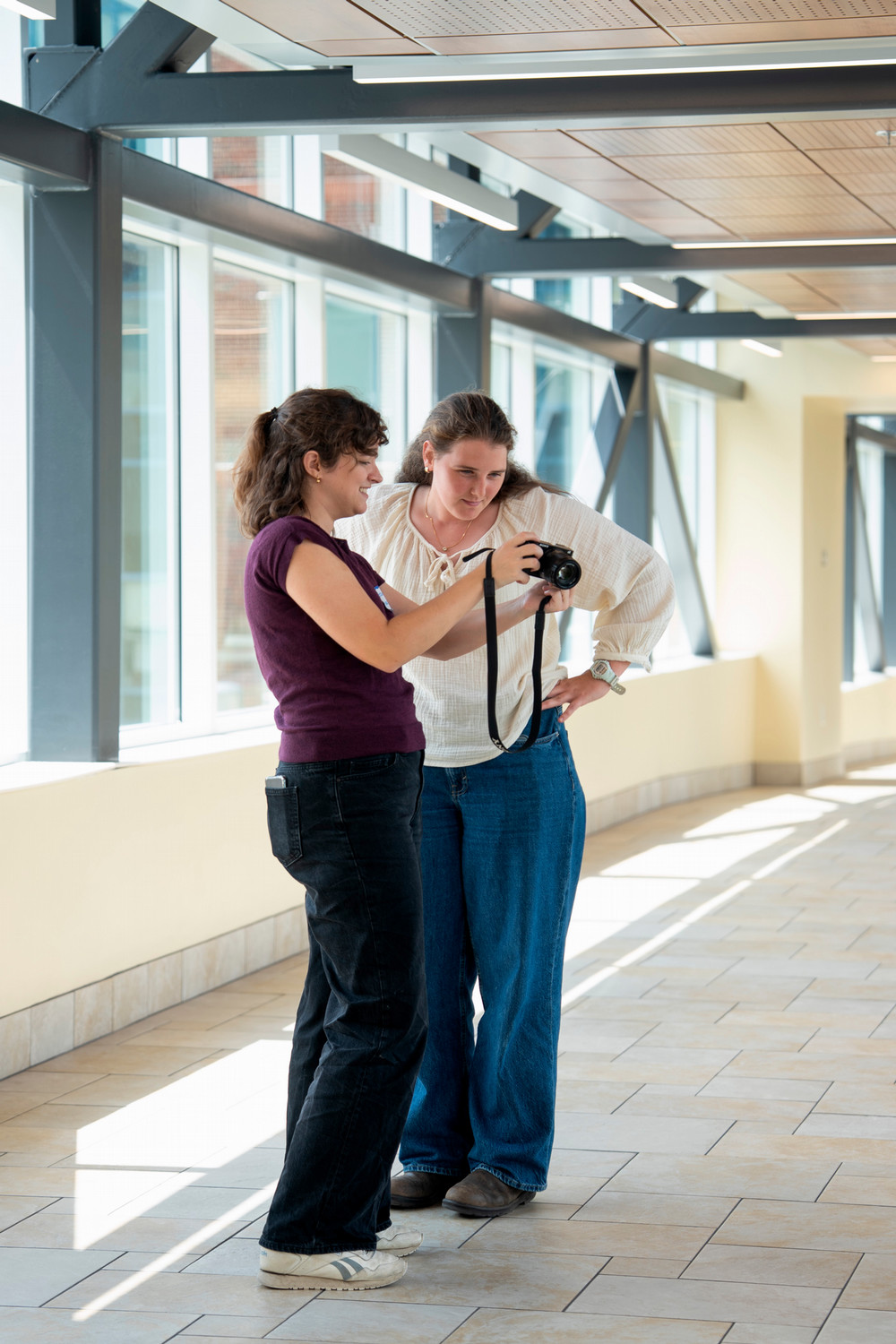 students at SSC skybridge looking at a camera