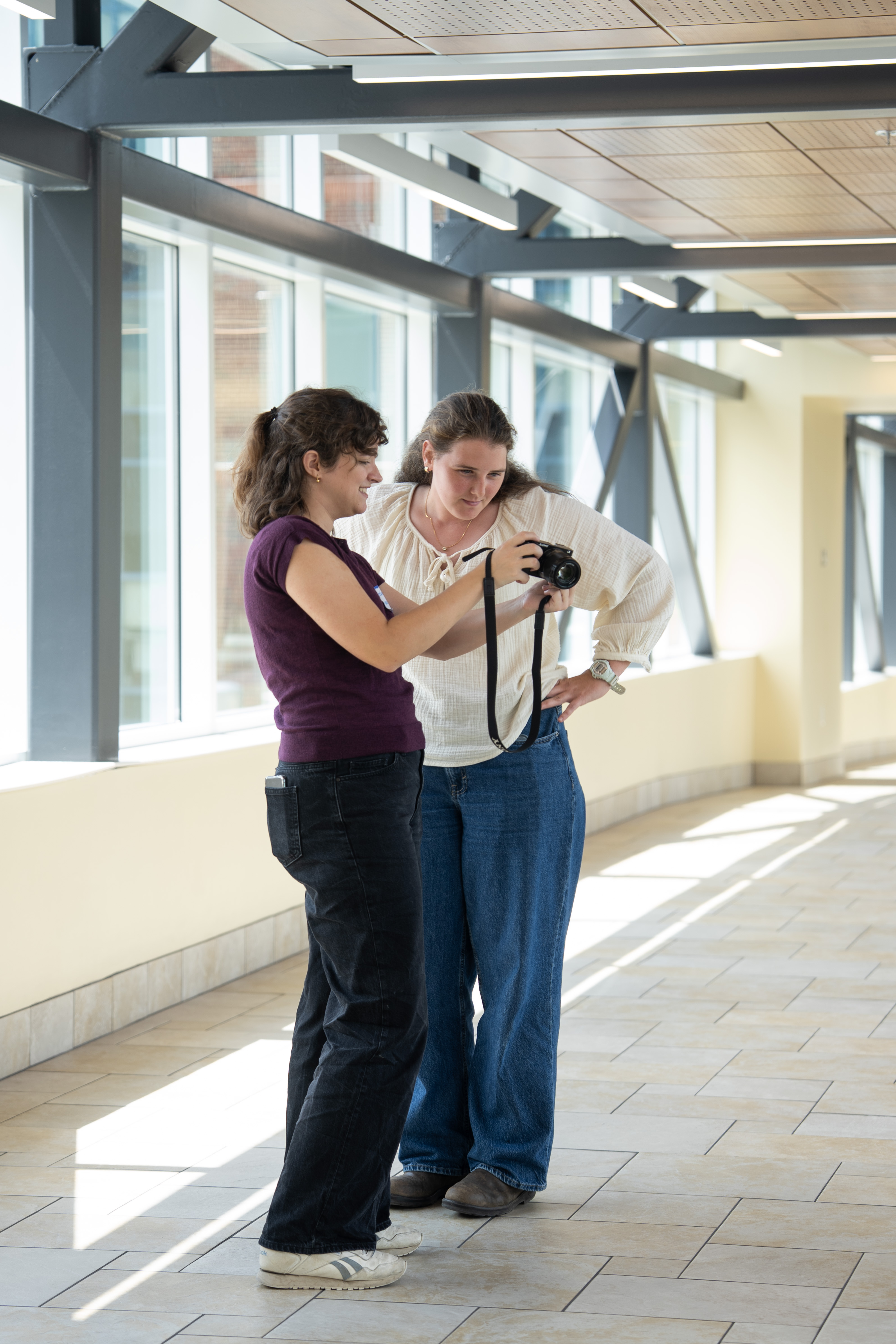 students at SSC skybridge looking at a camera
