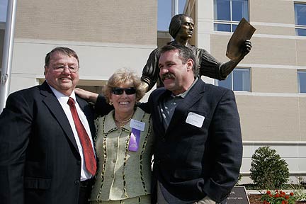 Bruce and Lois Forbes and Lee Leuning in front of the statue