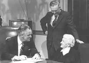 Mrs. Johnston chats with Governor Godwin after he signed the bill creating James Madison University. Her son-in-law, Tom Rice, looks on.