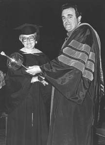 Emily L. lee presents the JMU Mace to President Ronald Carrier