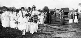 Elizabeth Kelly, the first May Queen, leads her Court in the 1913 celebration.
