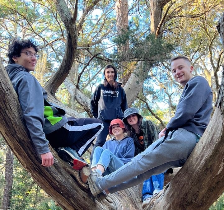 The 2022 Cumberland Island group poses in a giant tree