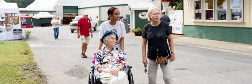 Student assisting VA Mennonite Retirement Community resident at the county fair.