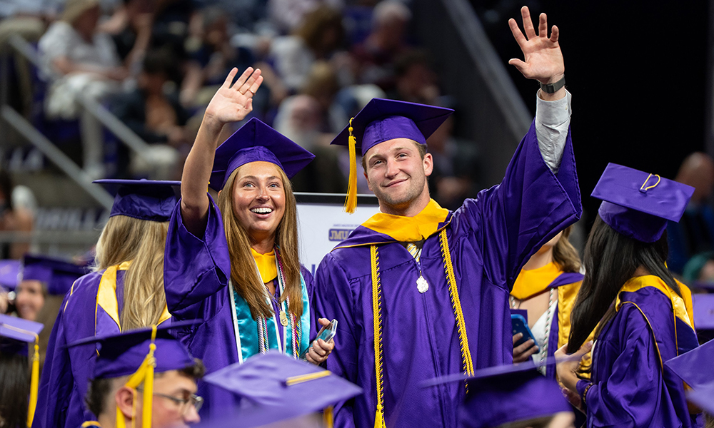 Students wave at spring 2026 commencement