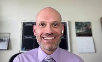 Dr. Brian Lusk sitting in his office.