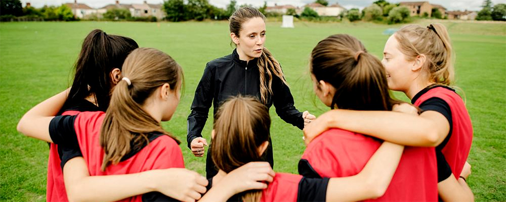 Photo of a woman coaching a girl's team