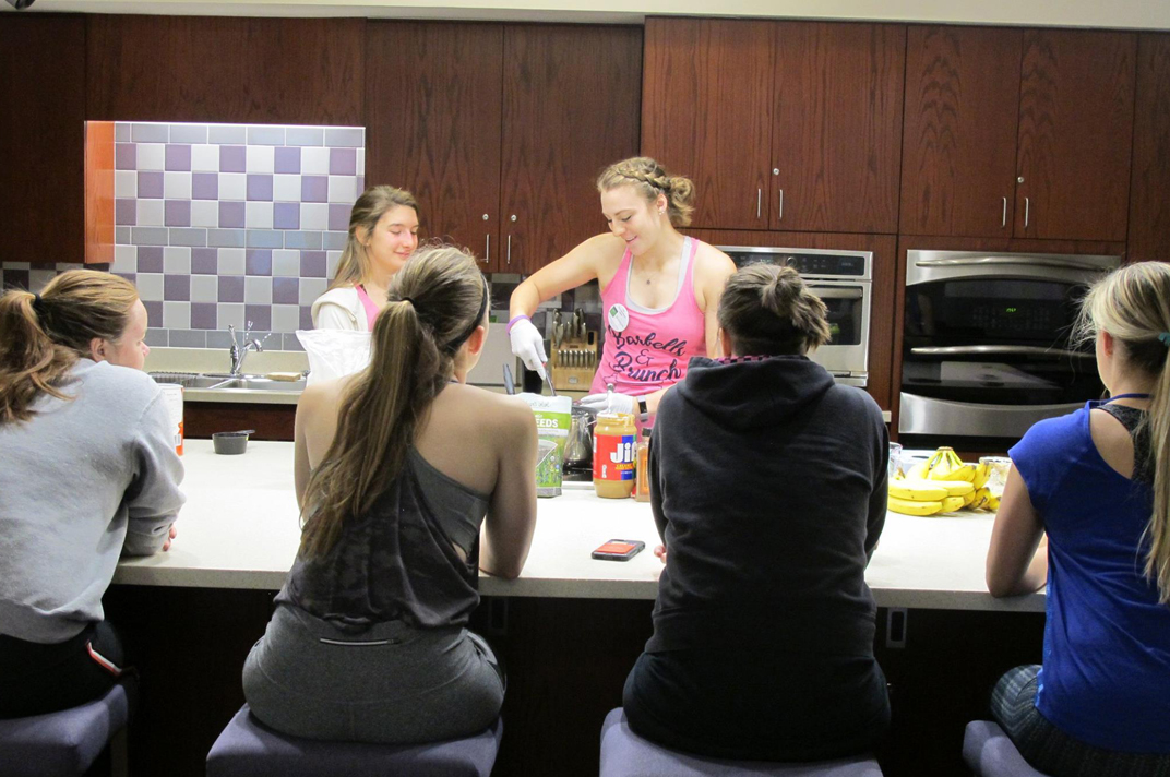 women preparing food in a urec kitchen