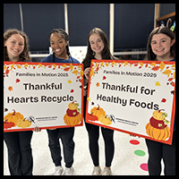 Families In Motion - Students posing with banners