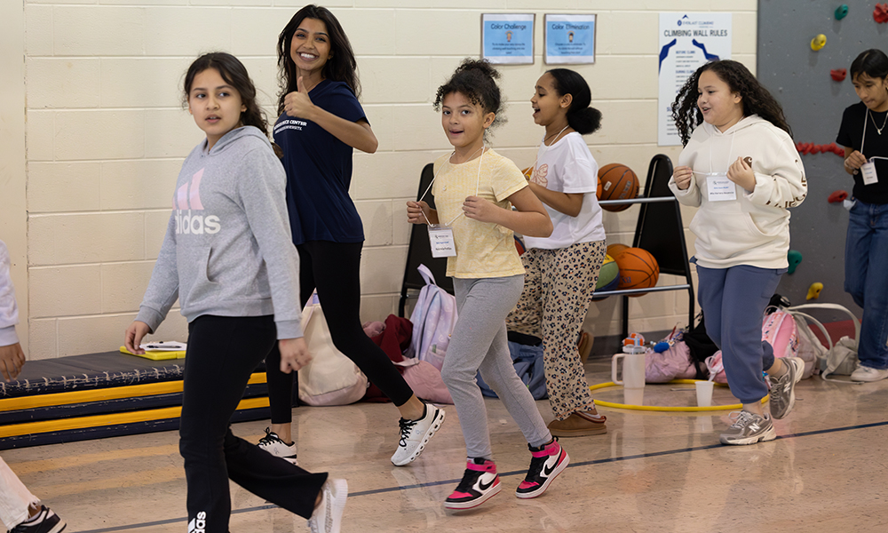 Girls Have H.E.A.R.T. staff and participants enjoying a run indoors