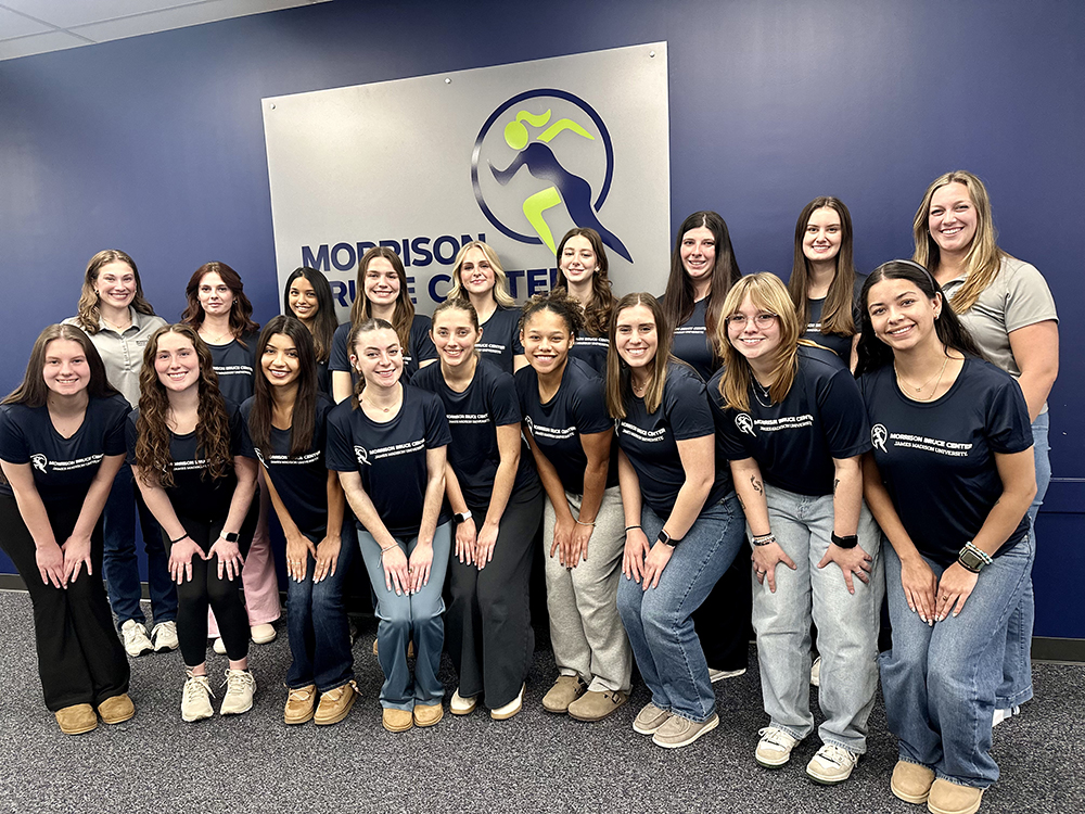 Group photo of the Spring 2026 Morrison Sports Management team, featuring staff members wearing matching navy T-shirts in a professional setting.