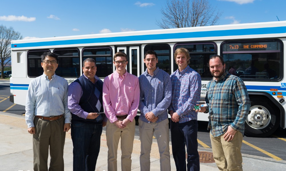 JMU professors and students near bus