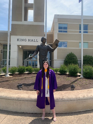 Chelsea Lang standing in front of JMU's King Hall