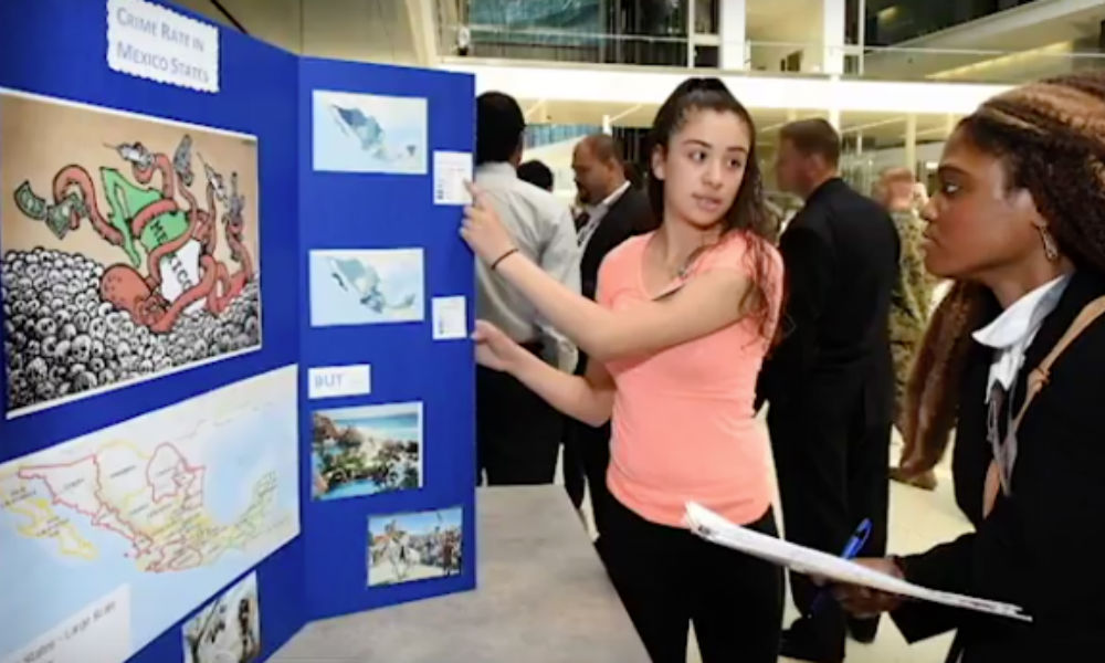 Female students discussing GIS poster