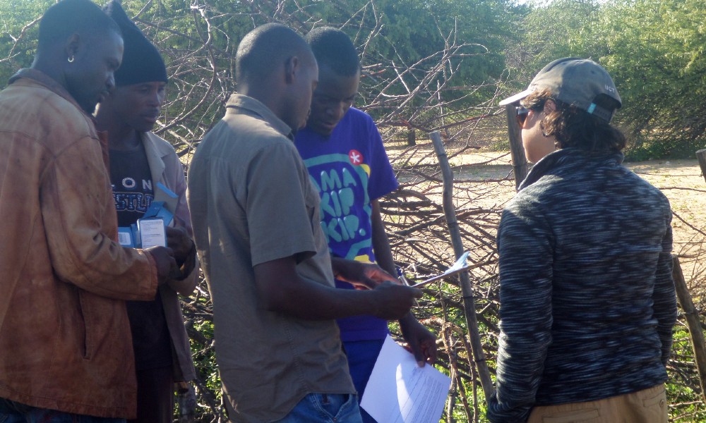 GS alum Gabi Fleury with farmers determining what killed their calf using educational key