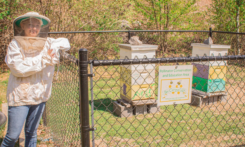 Student dressed in beekeeping suit