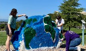 Geography students painting spirit rock