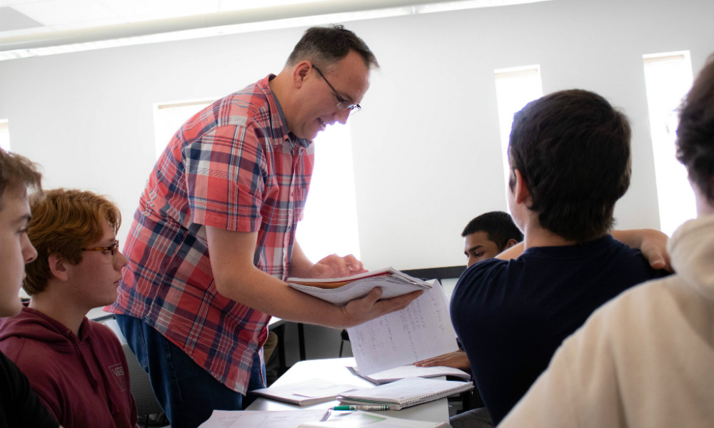 Chris Mayfield working with a group of CS students